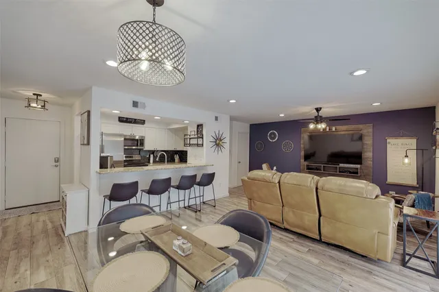 a view of a dining room with furniture wooden floor and chandelier