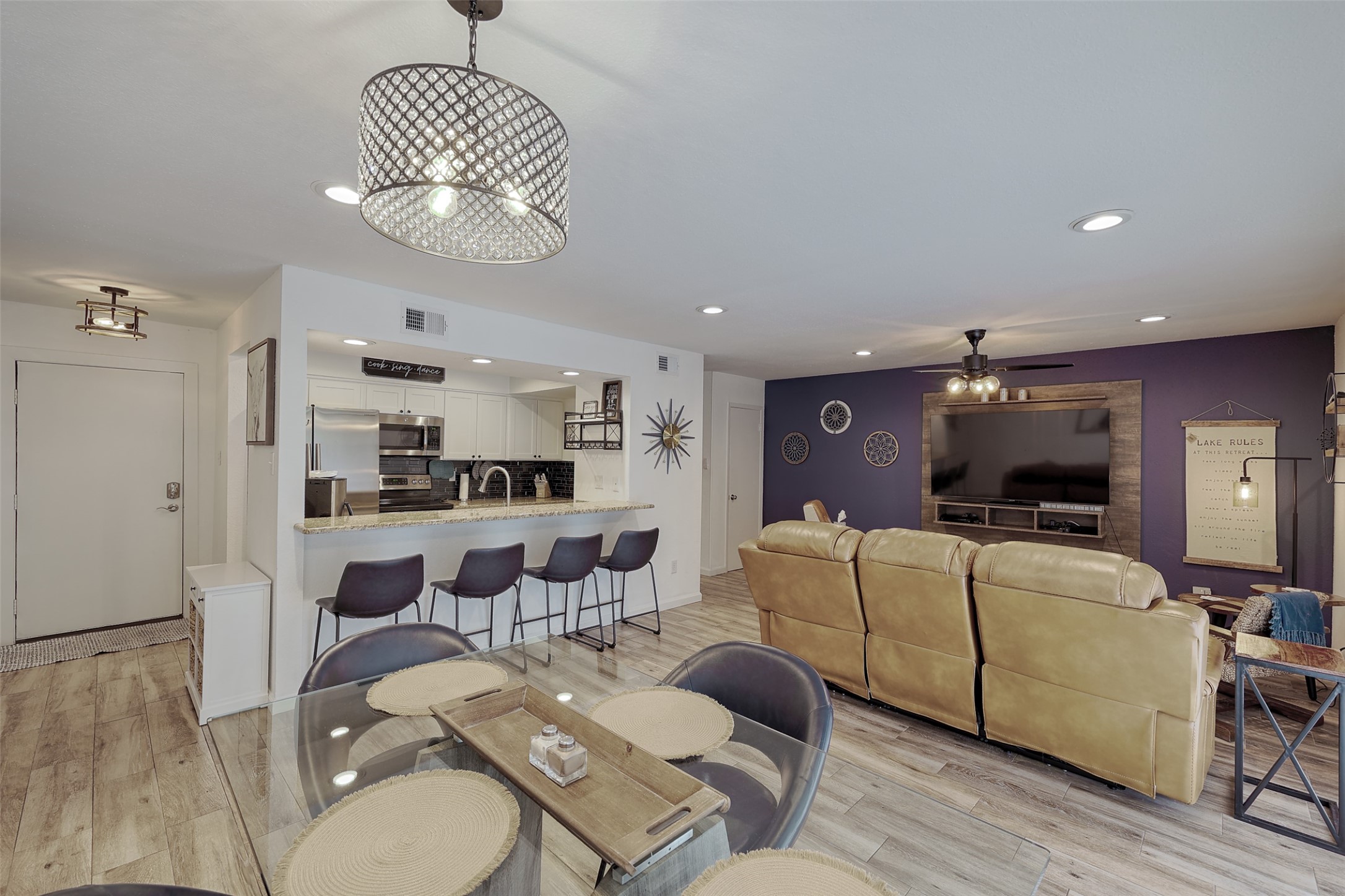 a view of a dining room with furniture wooden floor and chandelier