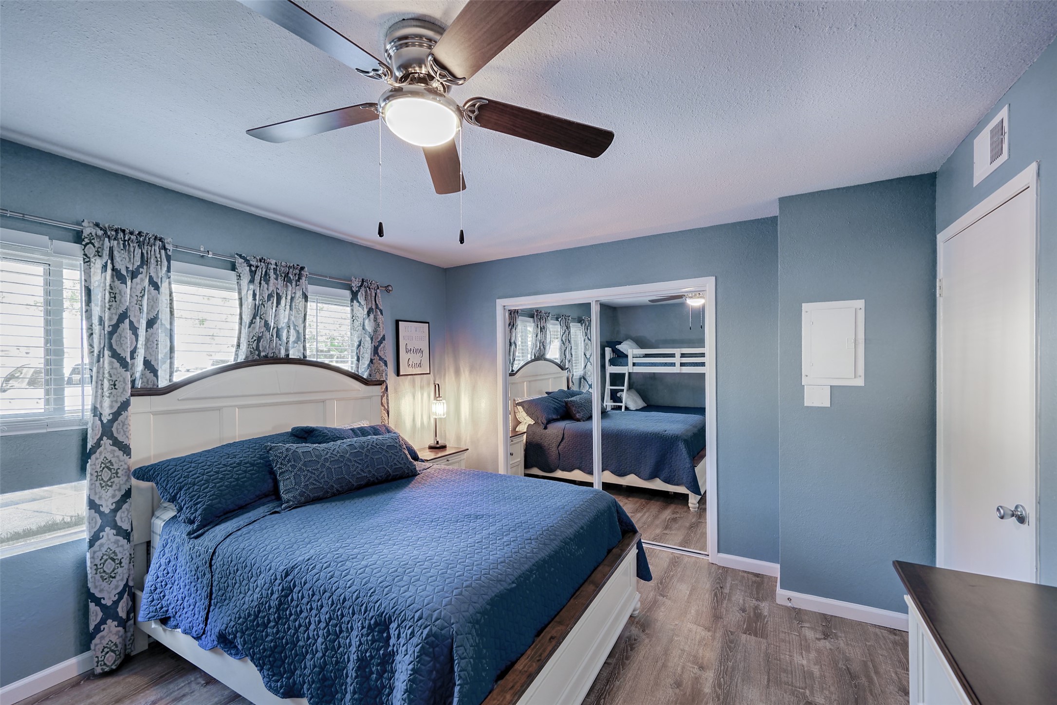12500 Melville Drive, Unit 123C Montgomery, TX 77356 - Photo 11 of 31 a bedroom with a large bed and a chandelier