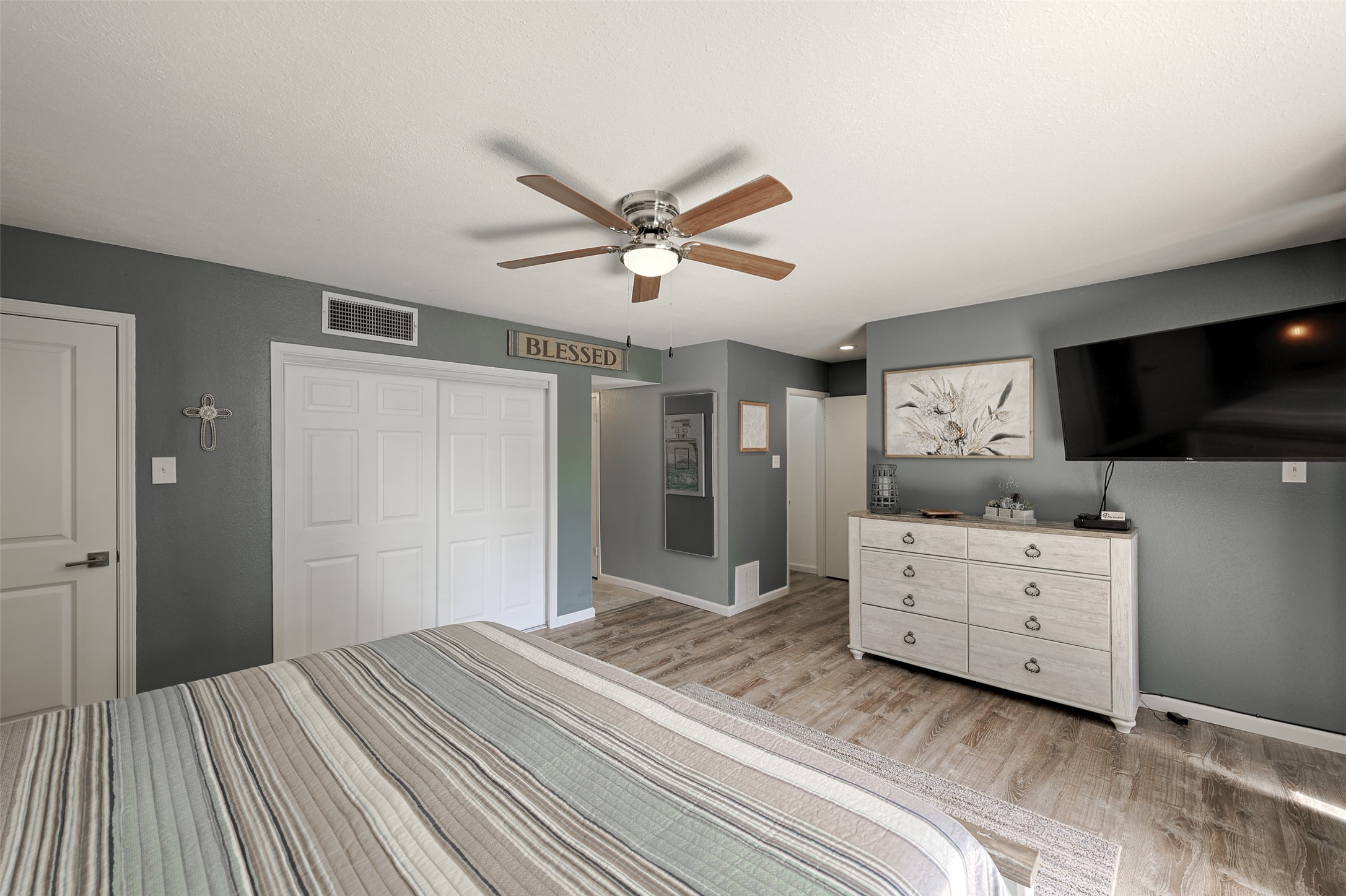 12500 Melville Drive, Unit 123C Montgomery, TX 77356 - Photo 16 of 31 a bedroom with a bed and a flat screen tv