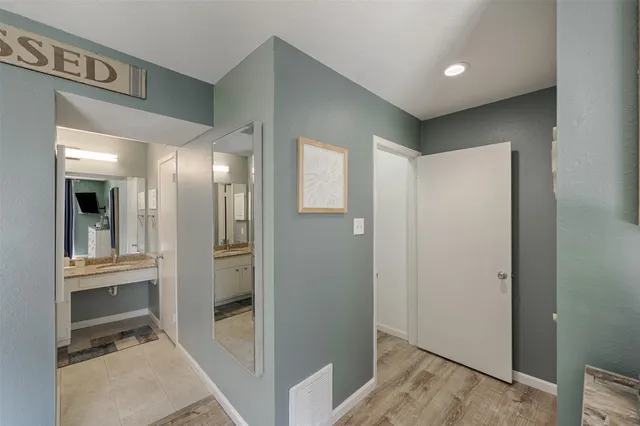 a view of a hallway with wooden floor