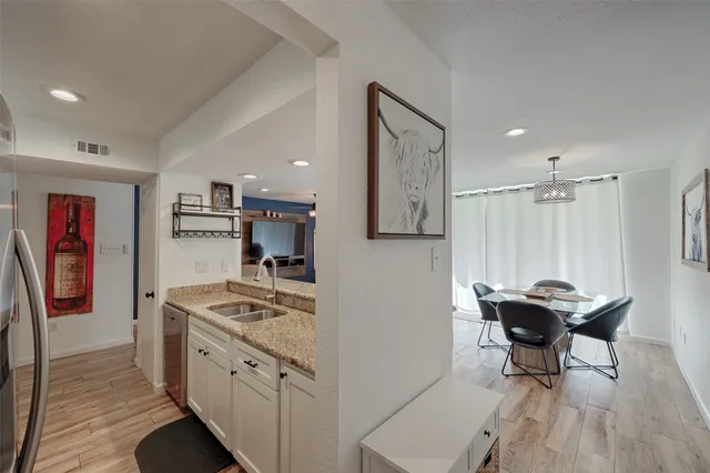 a kitchen with stainless steel appliances kitchen island granite countertop furniture and a refrigerator