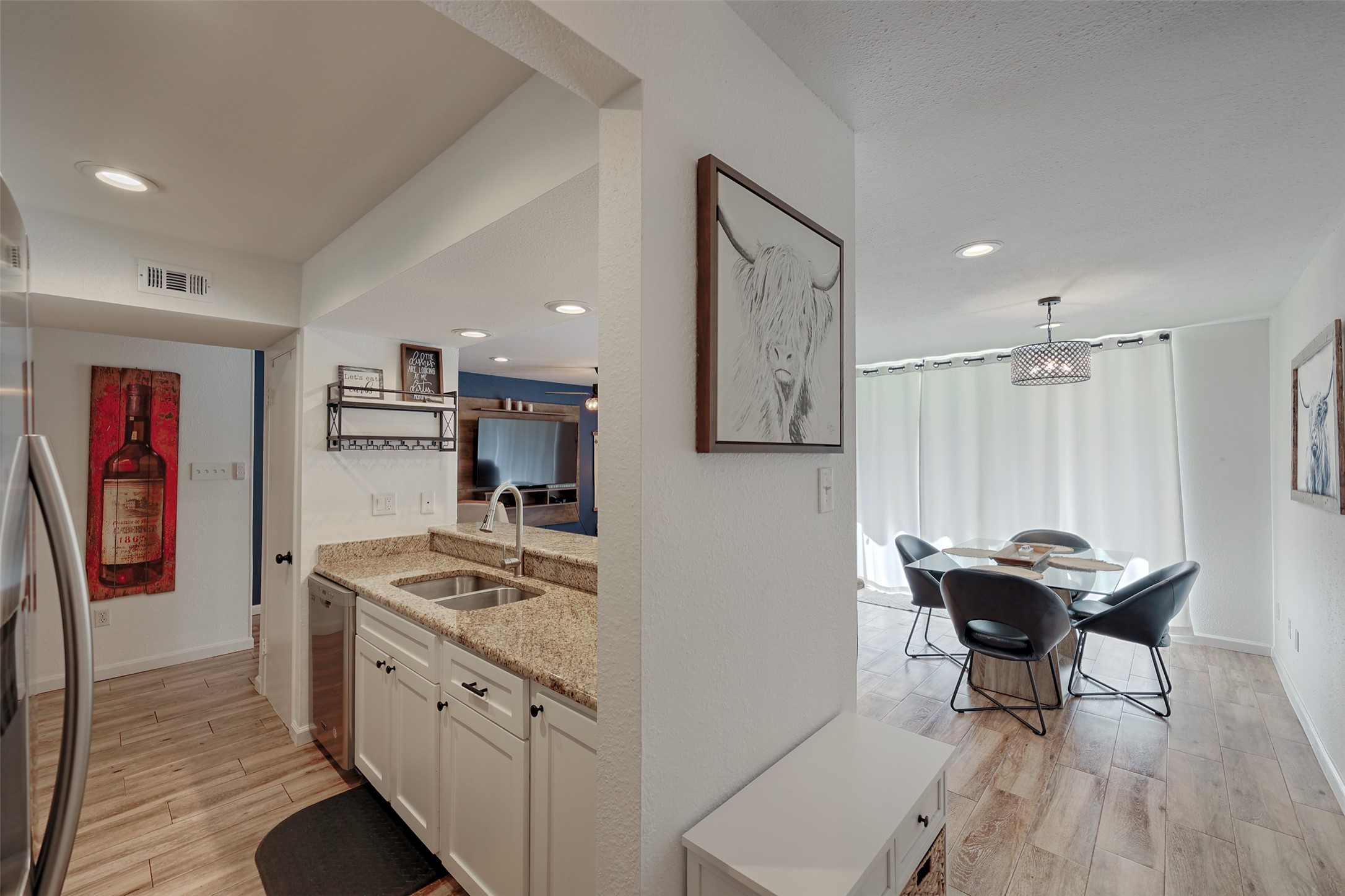 12500 Melville Drive, Unit 123C Montgomery, TX 77356 - Photo 2 of 31 a kitchen with stainless steel appliances kitchen island granite countertop furniture and a refrigerator