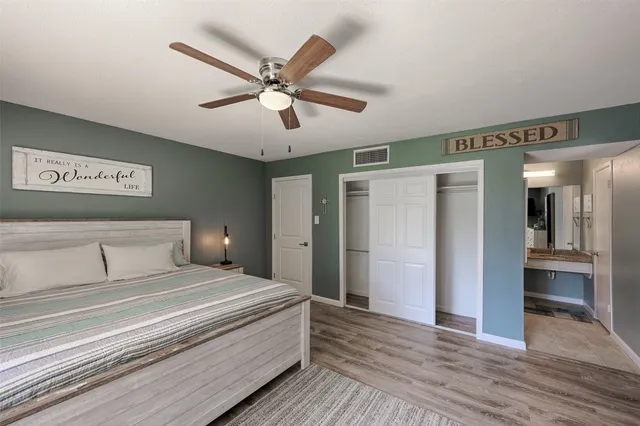 a bedroom with a large bed and a chandelier