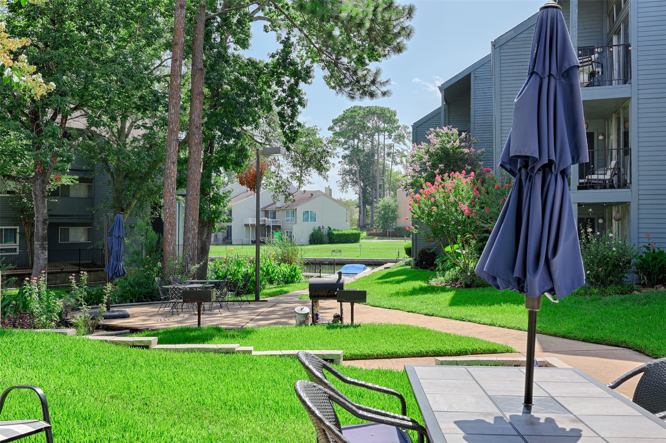 12500 Melville Drive, Unit 123C Montgomery, TX 77356 - Photo 28 of 31 a garden with plants and large trees