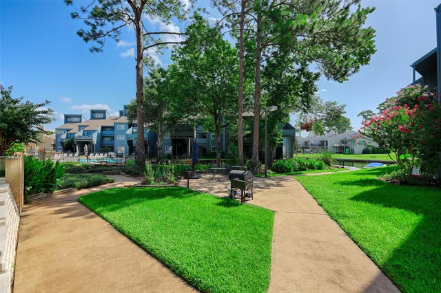 a view of a patio with a table and chairs under an umbrella