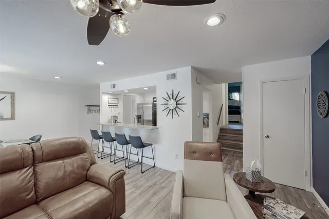 a living room with furniture a couch and chandelier
