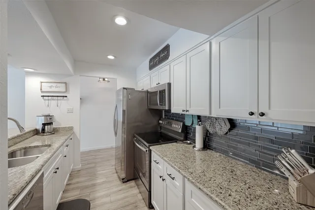 a kitchen with a refrigerator sink and stove