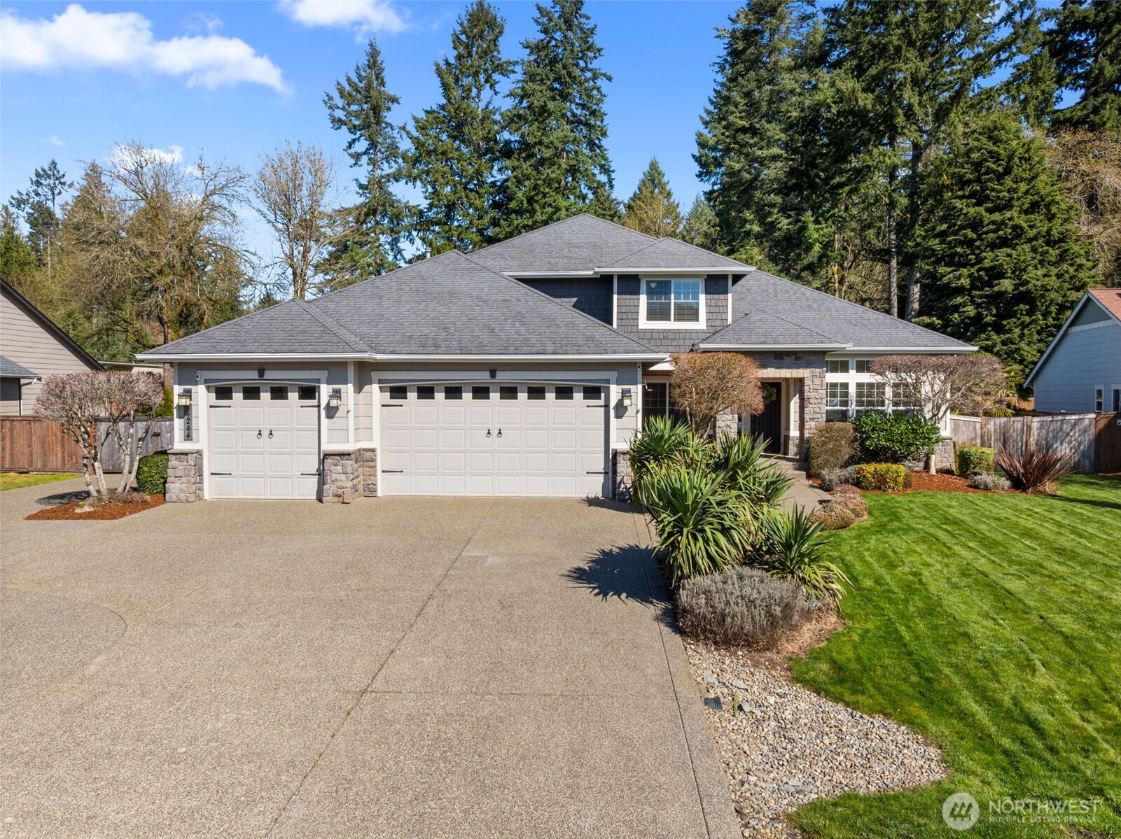 4244 90th Way Southeast Olympia, WA 98501 - Photo 2 of 40 a house with a garden in front of it