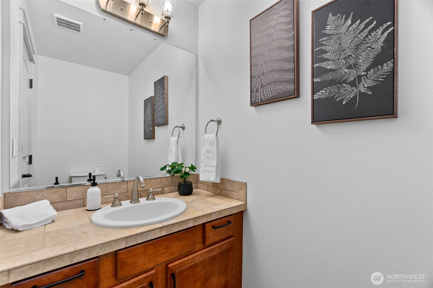 4244 90th Way Southeast Olympia, WA 98501 - Photo 22 of 40 a bathroom with a sink and a mirror