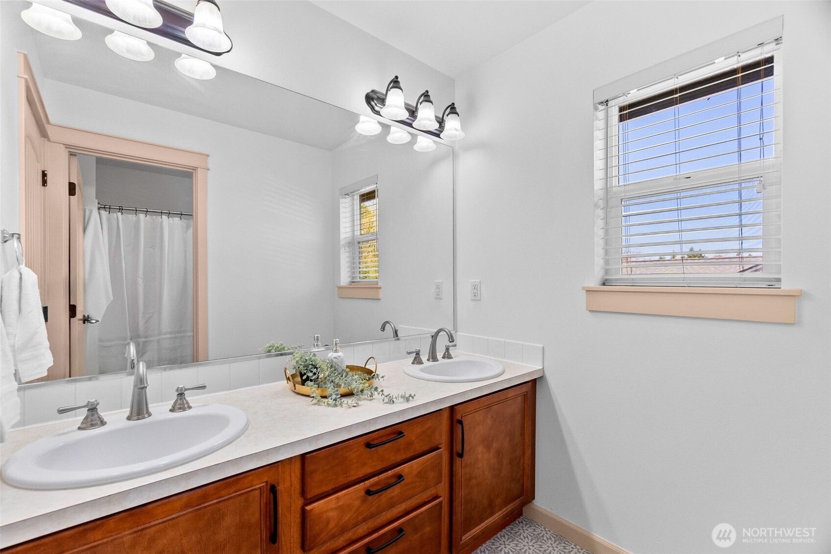 4244 90th Way Southeast Olympia, WA 98501 - Photo 24 of 40 a bathroom with a double vanity sink and a mirror