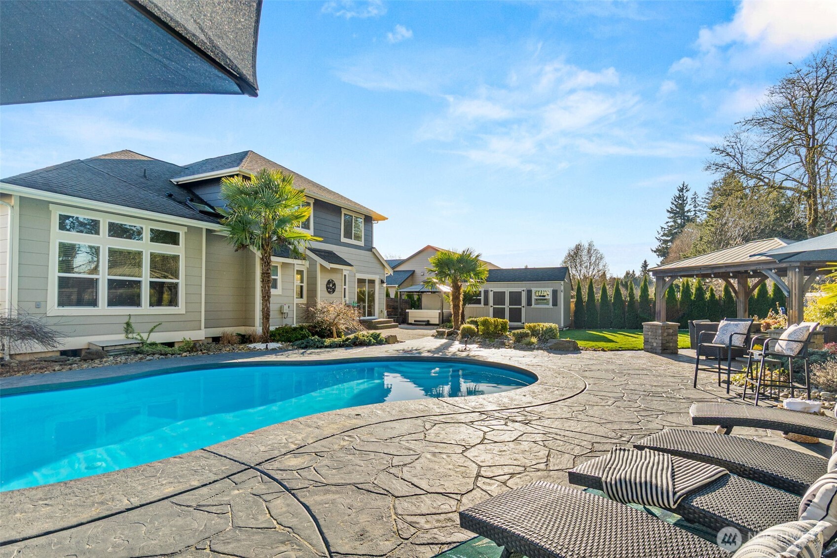 4244 90th Way Southeast Olympia, WA 98501 - Photo 26 of 40 a view of a house with swimming pool and sitting area