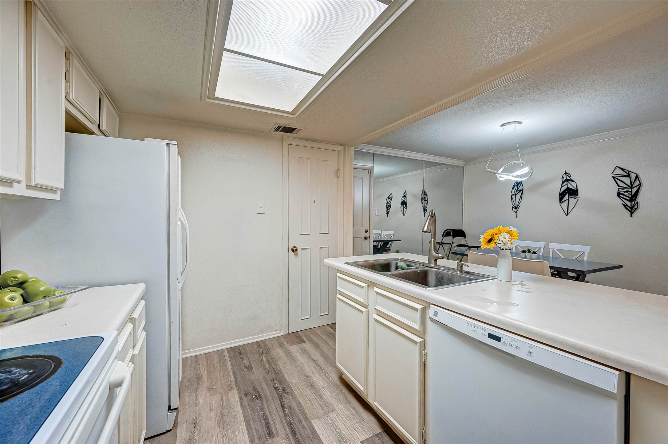 1908 Augusta Drive, Unit 7 Houston, TX 77057 - Photo 21 of 33 a kitchen with a sink cabinets and wooden floor