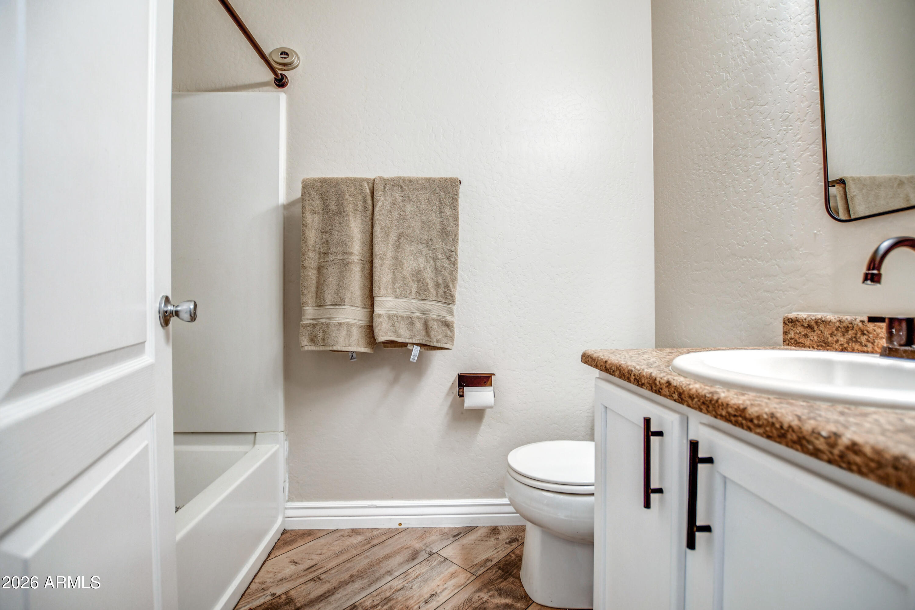 7515 South 30th Place Phoenix, AZ 85042 - Photo 14 of 23 a bathroom with a granite countertop sink toilet and shower