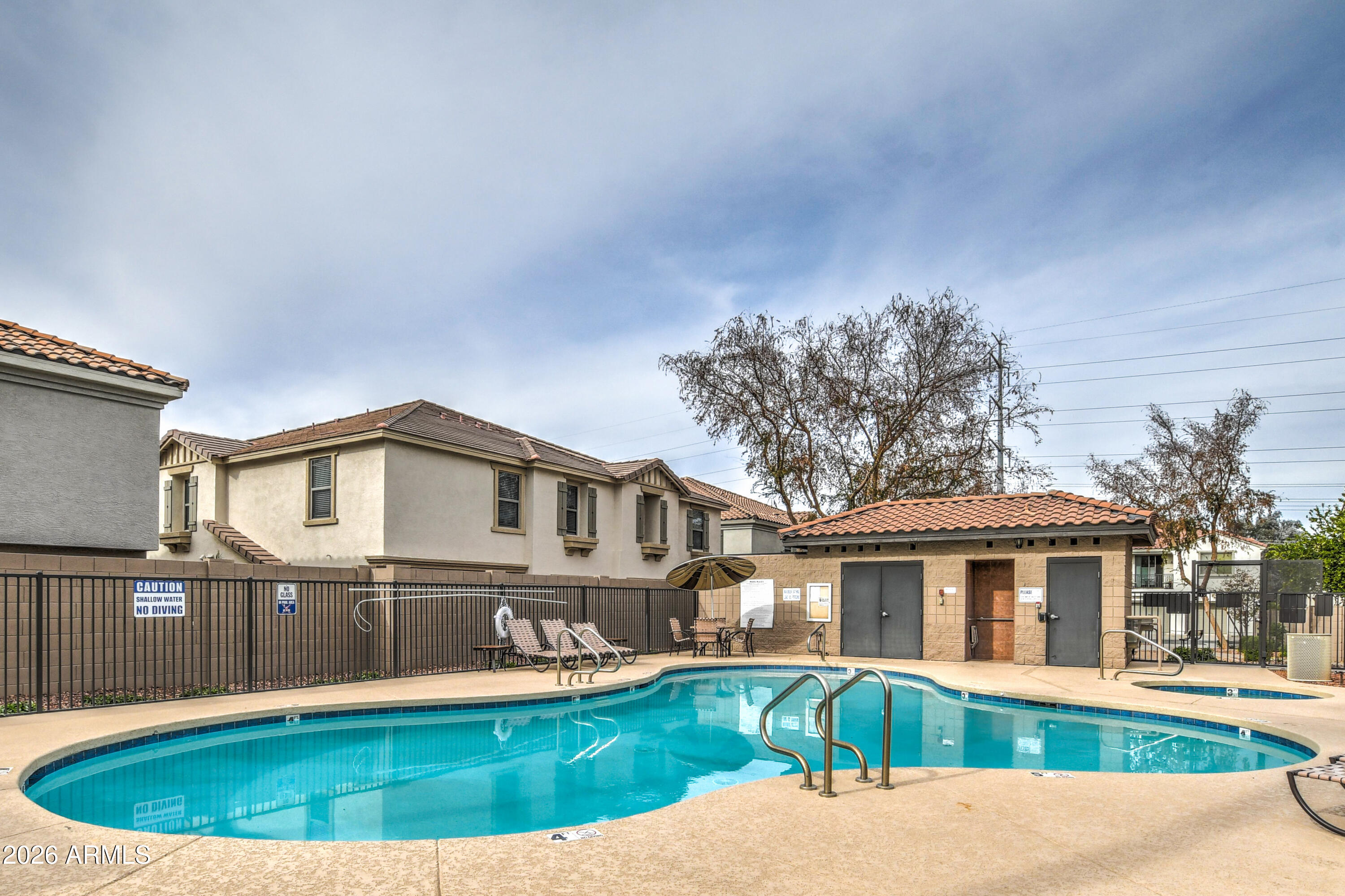 7515 South 30th Place Phoenix, AZ 85042 - Photo 18 of 23 a front view of a house with a yard table and chairs