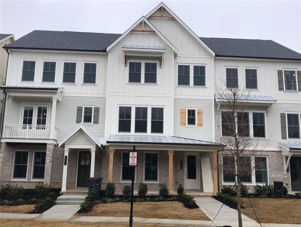 2005 Cortland Road, Unit 55 Milton, GA 30004 - Photo 1 of 1 a front view of a residential apartment building with a yard