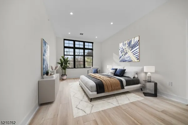 a spacious bedroom with a bed and a couch