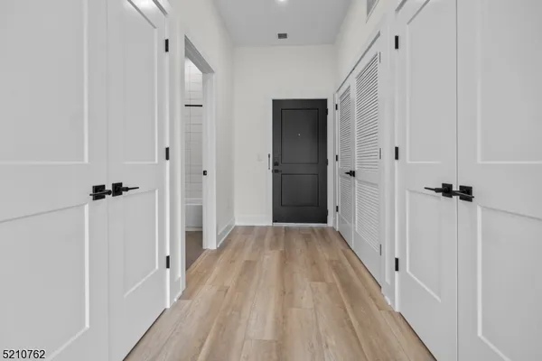 a view of a room with wooden floor