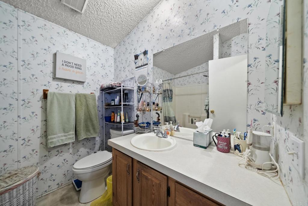 12044 Royal Road, Unit SPC 18 El Cajon, CA 92021 - Photo 11 of 24 a bathroom with a sink toilet vanity and shower