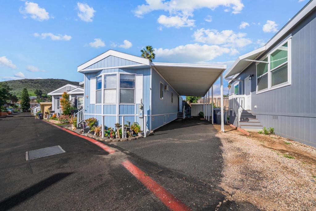 12044 Royal Road, Unit SPC 18 El Cajon, CA 92021 - Photo 2 of 24 a front view of a house with a garage
