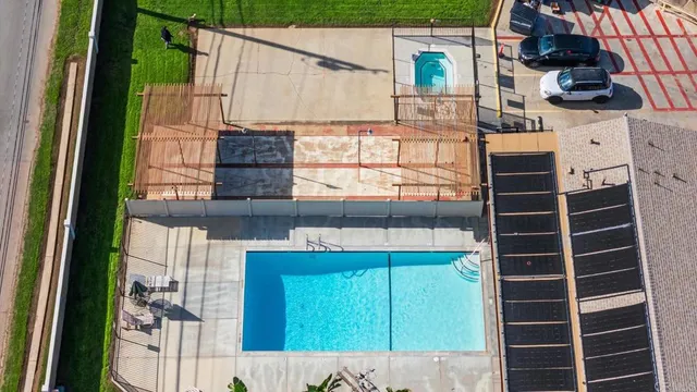 an aerial view of a house with garden space and street view