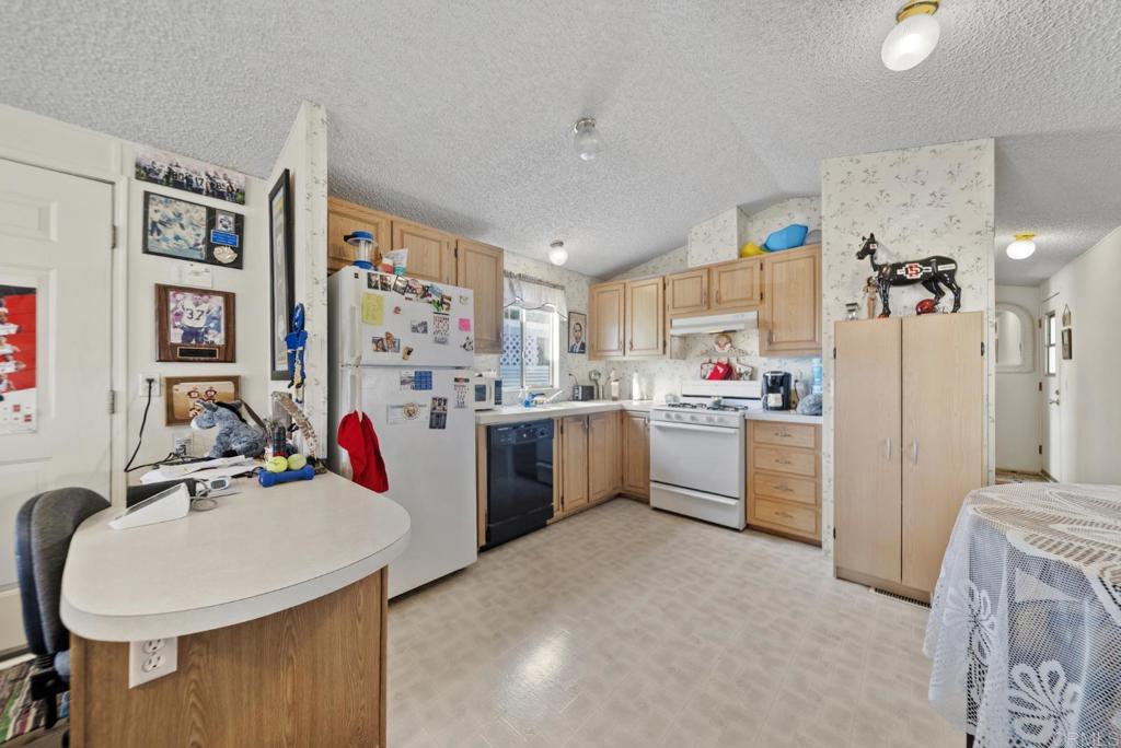 12044 Royal Road, Unit SPC 18 El Cajon, CA 92021 - Photo 3 of 24 a storage room with cabinets a sink and appliances