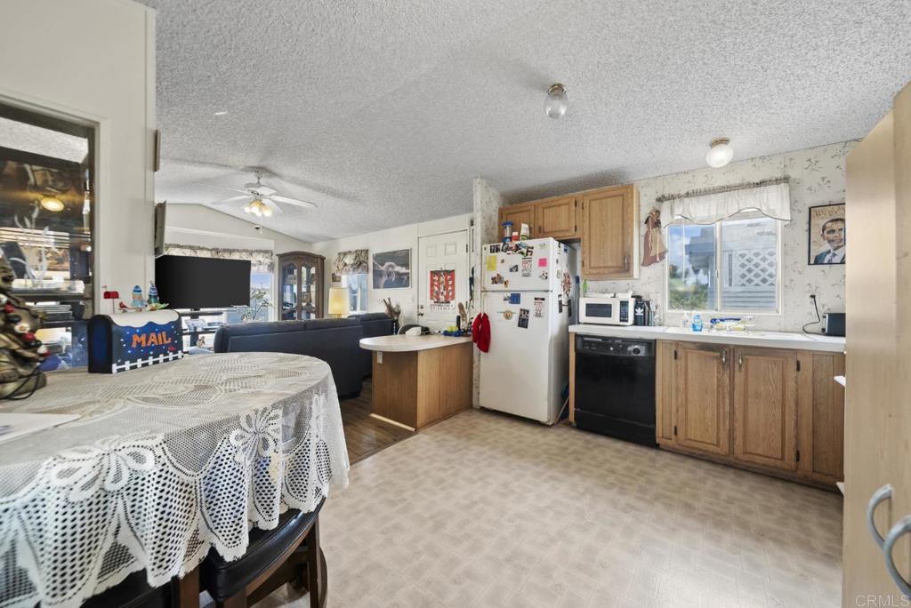 12044 Royal Road, Unit SPC 18 El Cajon, CA 92021 - Photo 5 of 24 a kitchen that has a lot of cabinets in it and appliances