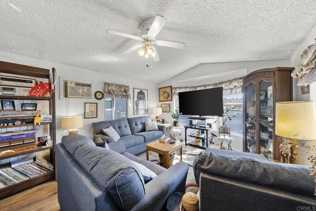 12044 Royal Road, Unit SPC 18 El Cajon, CA 92021 - Photo 6 of 24 a living room with furniture and a flat screen tv