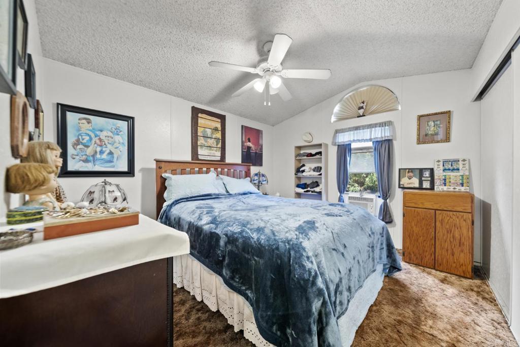 12044 Royal Road, Unit SPC 18 El Cajon, CA 92021 - Photo 9 of 24 a bed room with a bed and dresser