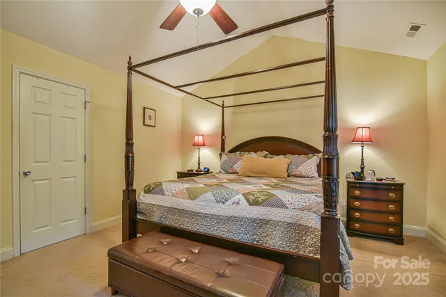 a bedroom with a bed and a flat tv screen