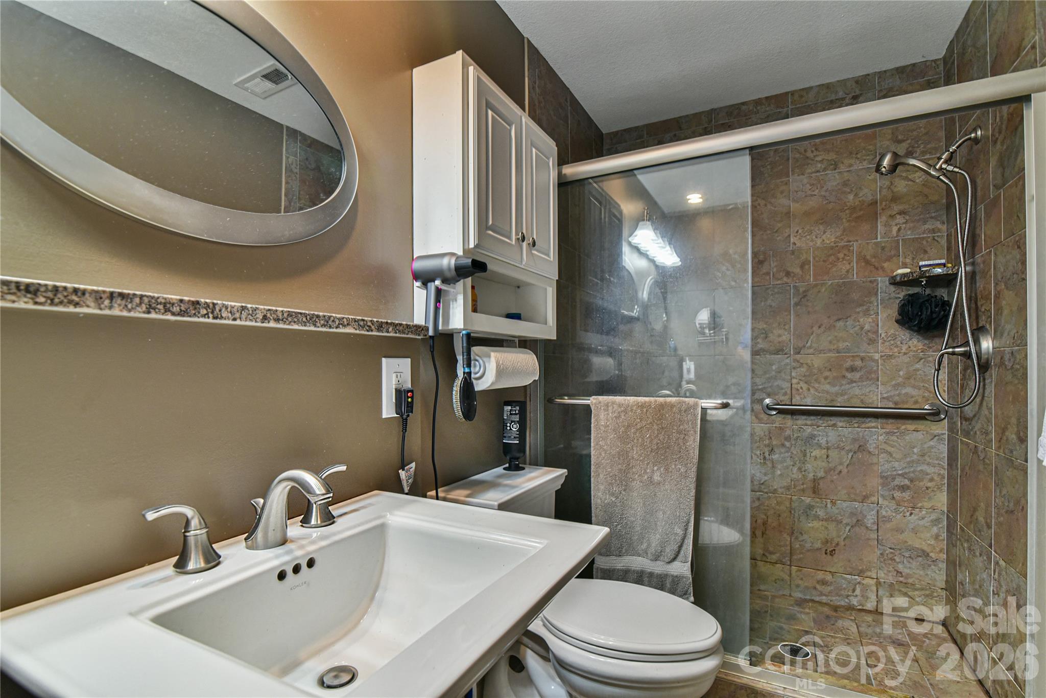 911 Fanning Bridge Road Fletcher, NC 28732 - Photo 22 of 28 a bathroom with a toilet a sink and shower