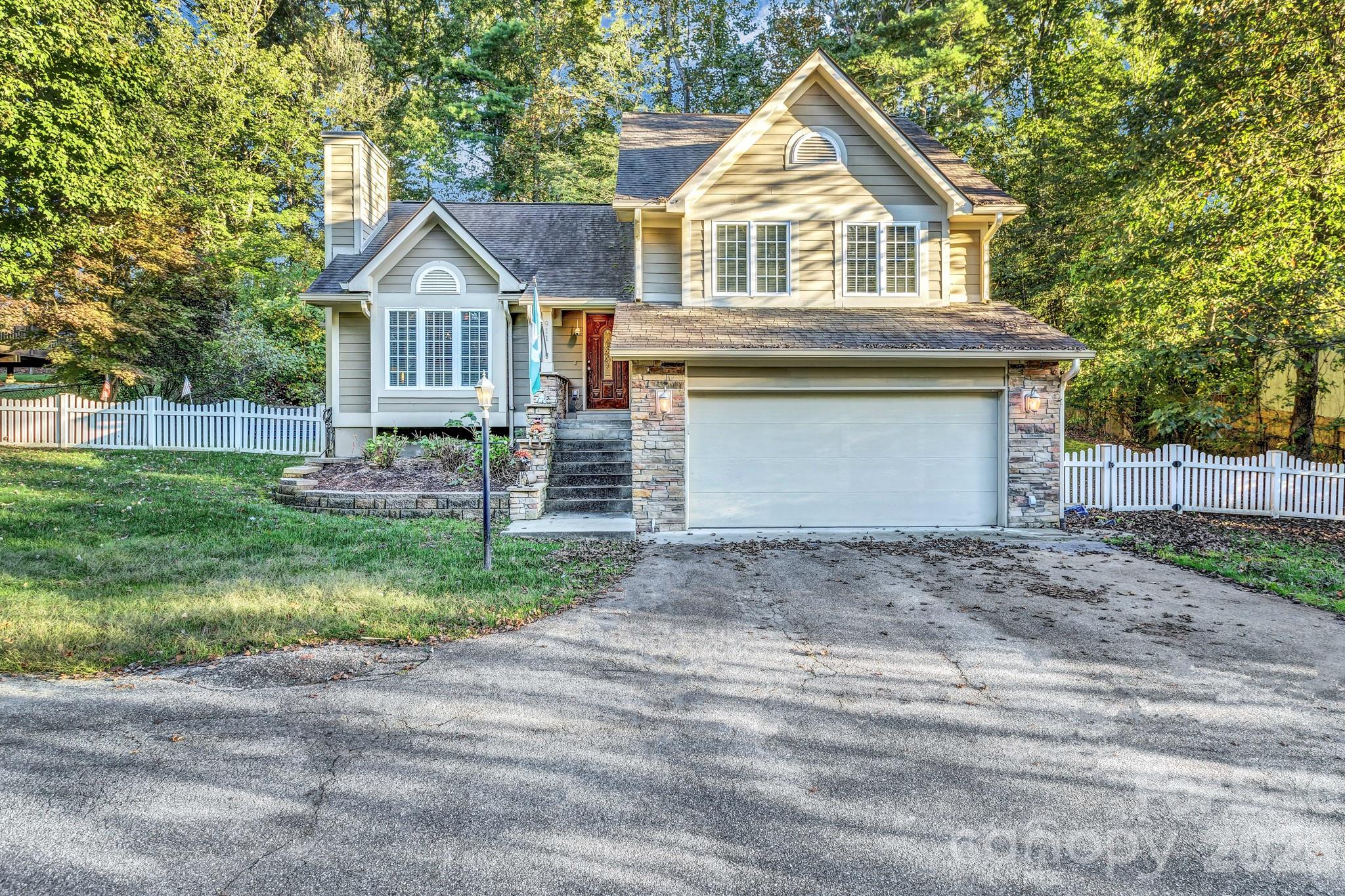 911 Fanning Bridge Road Fletcher, NC 28732 - Photo 27 of 28 a front view of a house with a yard and garage