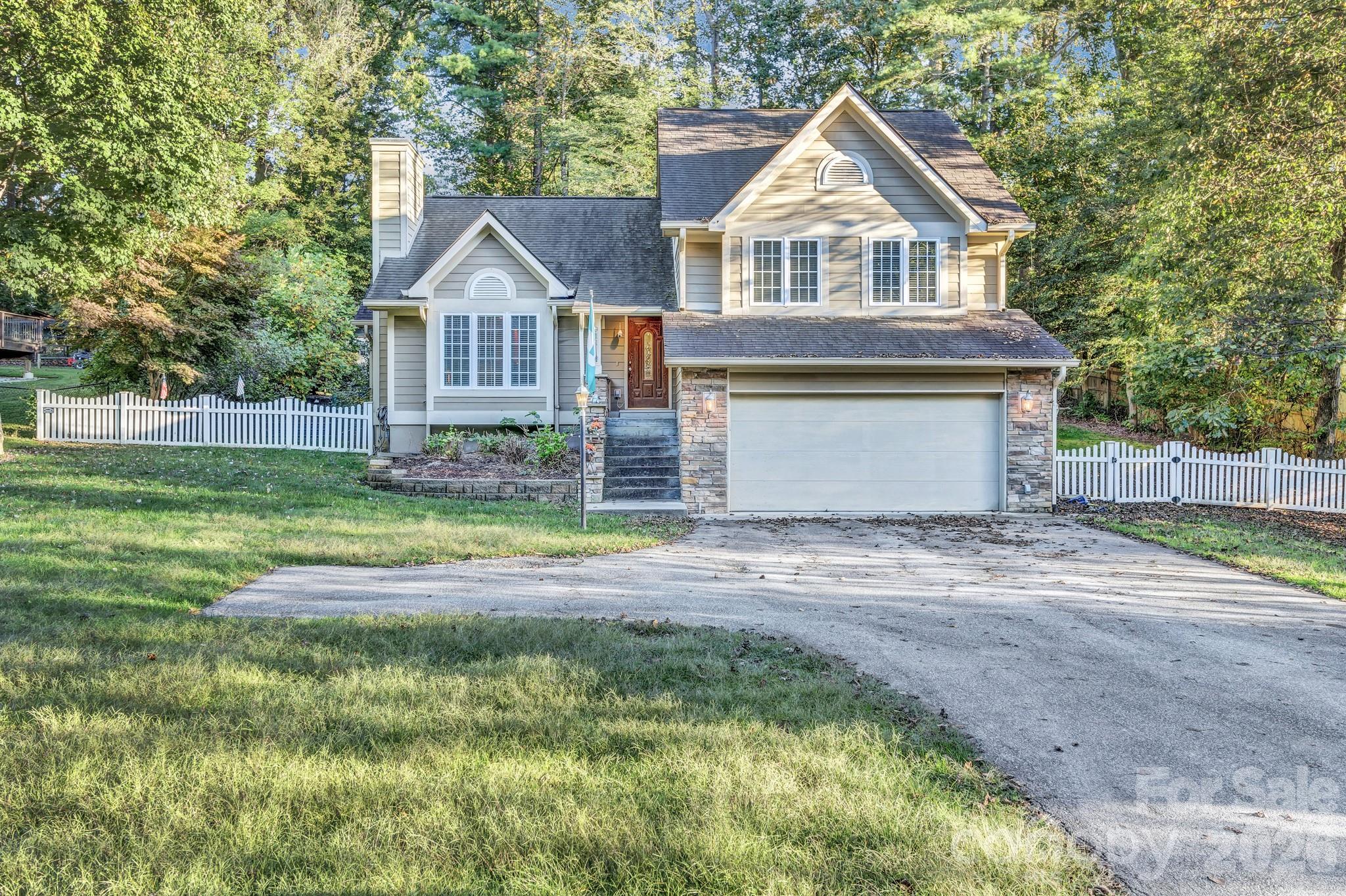 911 Fanning Bridge Road Fletcher, NC 28732 - Photo 28 of 28 a front view of a house with a yard and garage