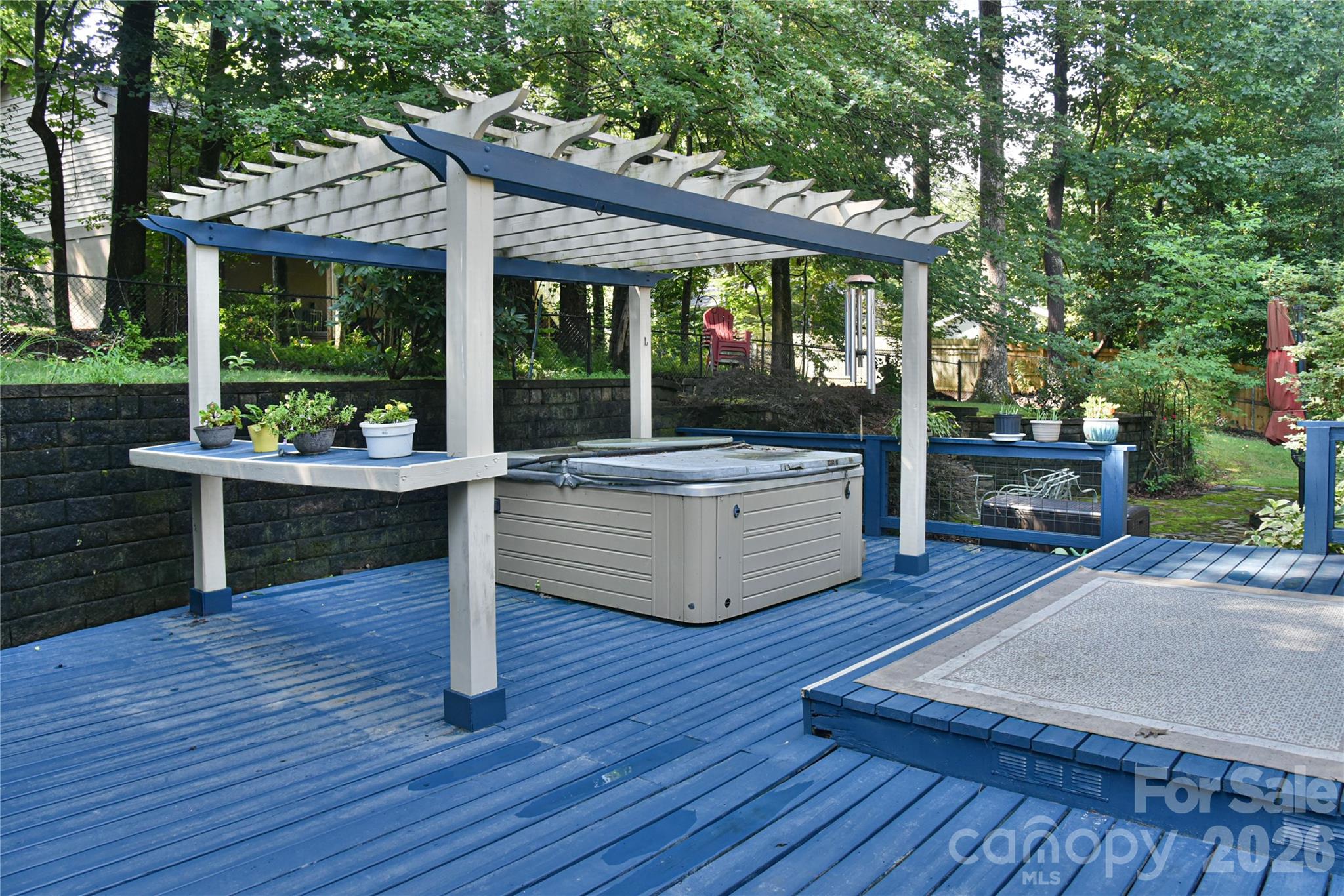 911 Fanning Bridge Road Fletcher, NC 28732 - Photo 3 of 28 a view of a patio with table and chairs potted plants with wooden floor and fence