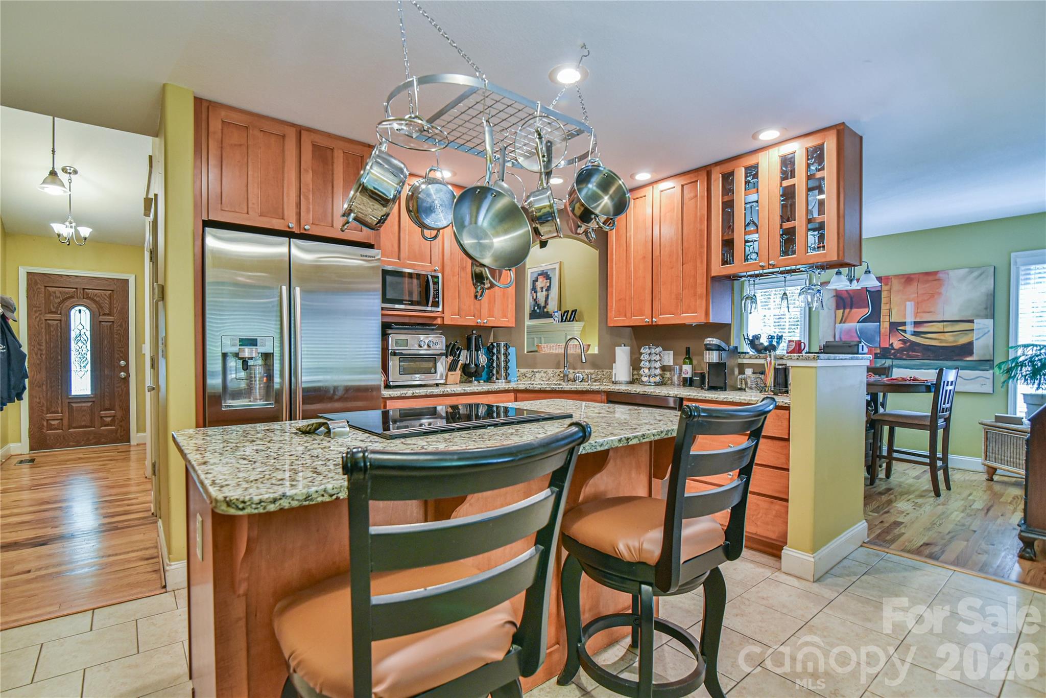 911 Fanning Bridge Road Fletcher, NC 28732 - Photo 5 of 28 a kitchen with stainless steel appliances granite countertop wooden cabinets a dining table and chairs