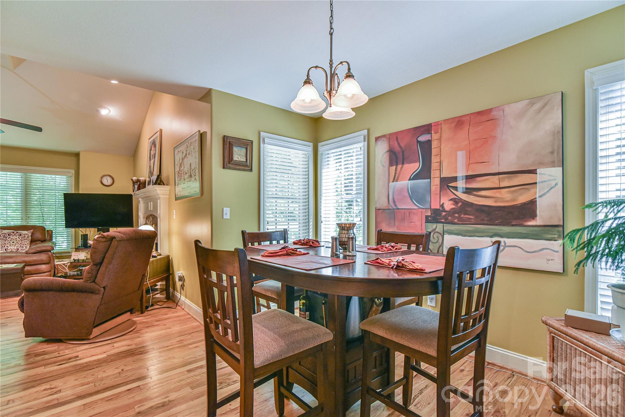 911 Fanning Bridge Road Fletcher, NC 28732 - Photo 9 of 28 a dining room with furniture a chandelier and wooden floor