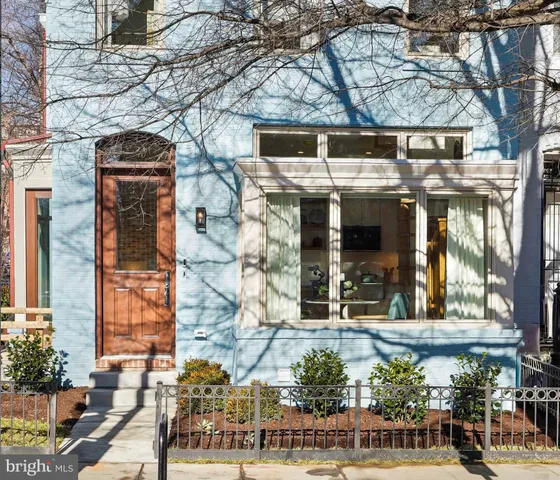 a front view of a building with a garden