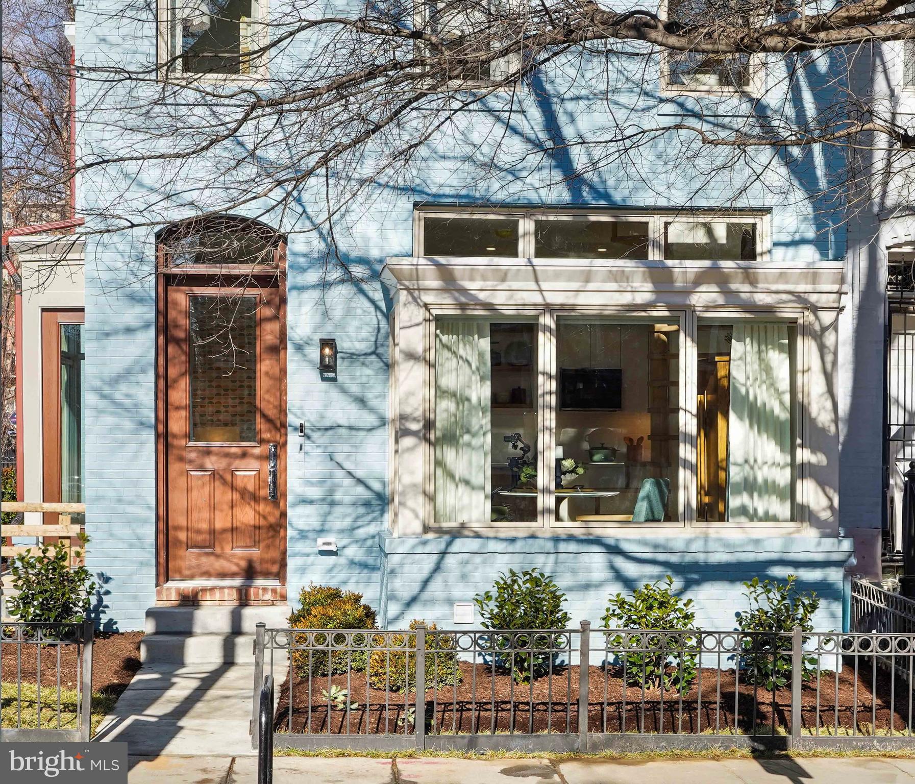 1237 W Street Northwest, Unit A Washington, DC 20009 - Photo 1 of 25 a front view of a building with a garden
