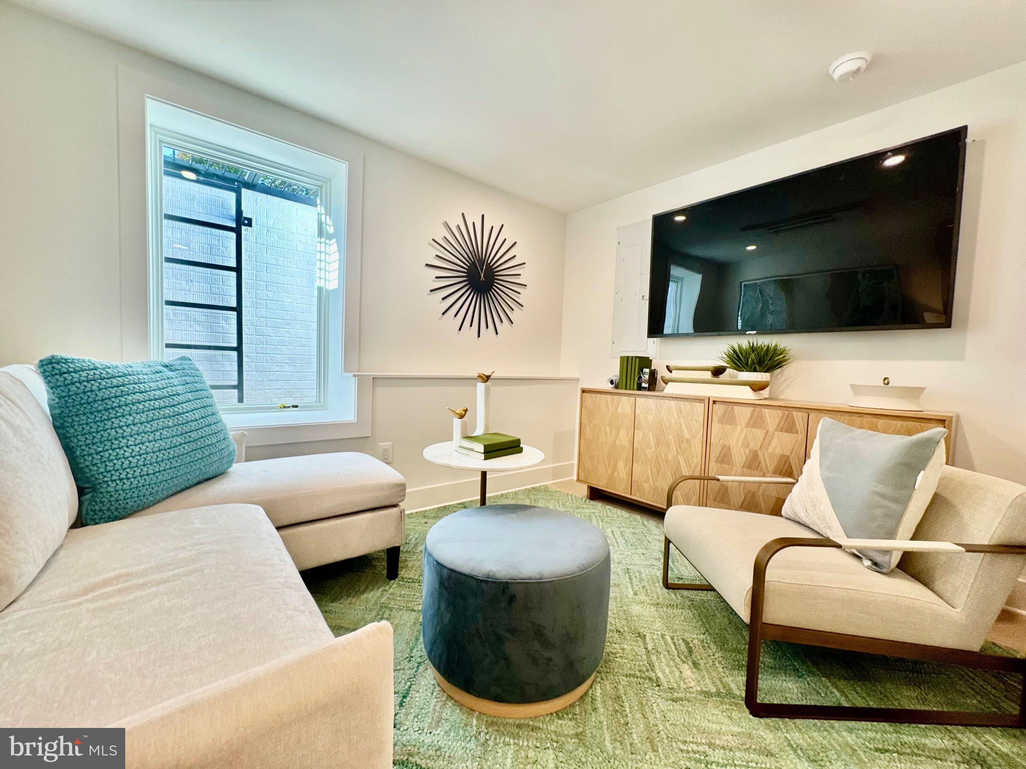 1237 W Street Northwest, Unit A Washington, DC 20009 - Photo 23 of 25 a living room with furniture and a flat screen tv