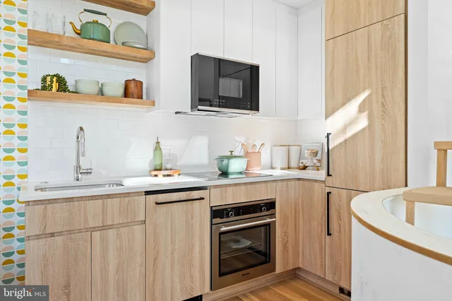 a kitchen with stainless steel appliances granite countertop a sink and a stove