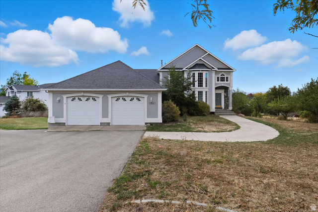 2887 View Crest Circle North Logan, UT 84341 - Photo 1 of 37 Traditional home with a shingled roof, a front lawn, driveway, and an attached garage