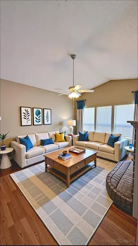a living room with furniture a rug and a chandelier