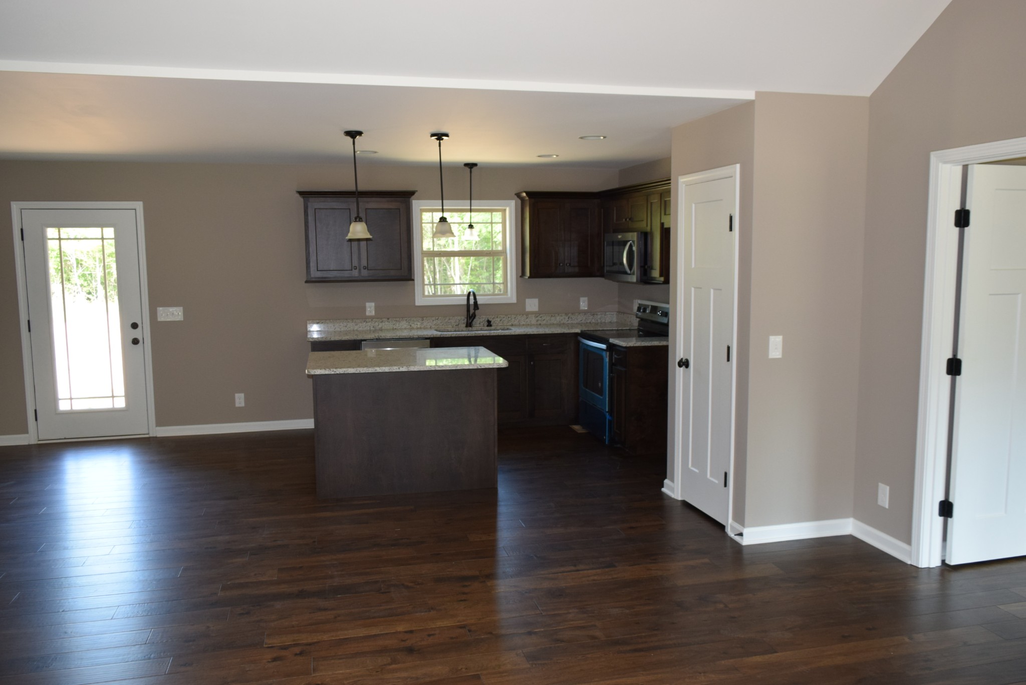 382 Ballard Road Manchester, TN 37355 - Photo 2 of 10 a kitchen with stainless steel appliances granite countertop a sink stove and wooden floor