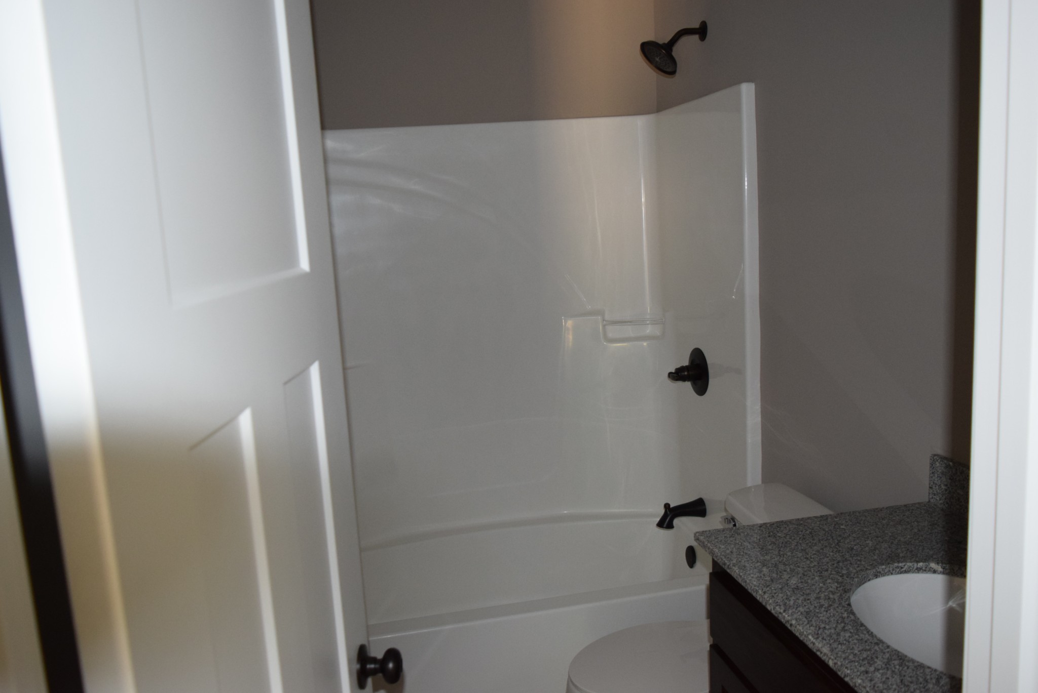 382 Ballard Road Manchester, TN 37355 - Photo 6 of 10 a bathroom with a granite countertop bathtub shower and toilet