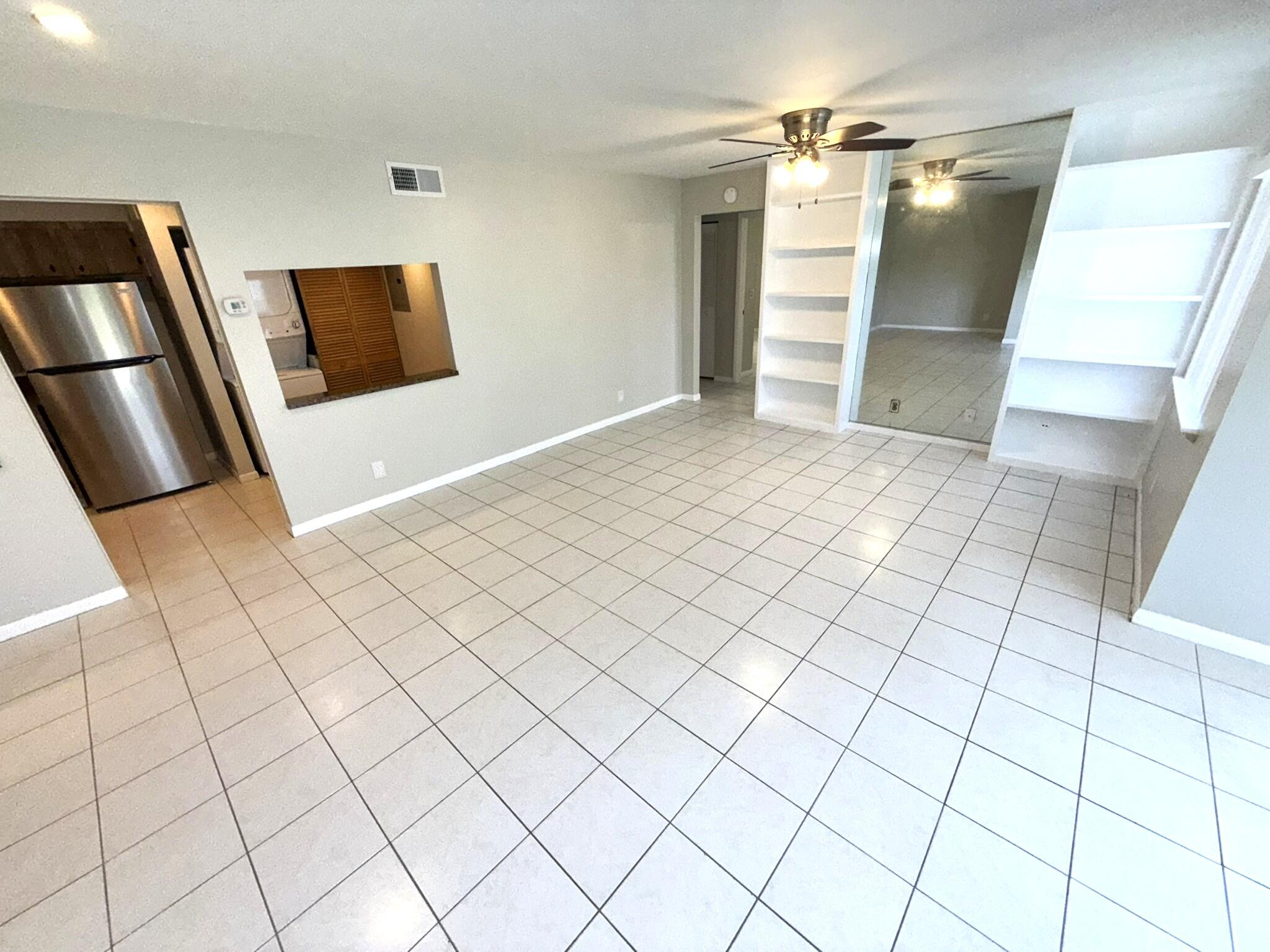 a view of a refrigerator and window in a room
