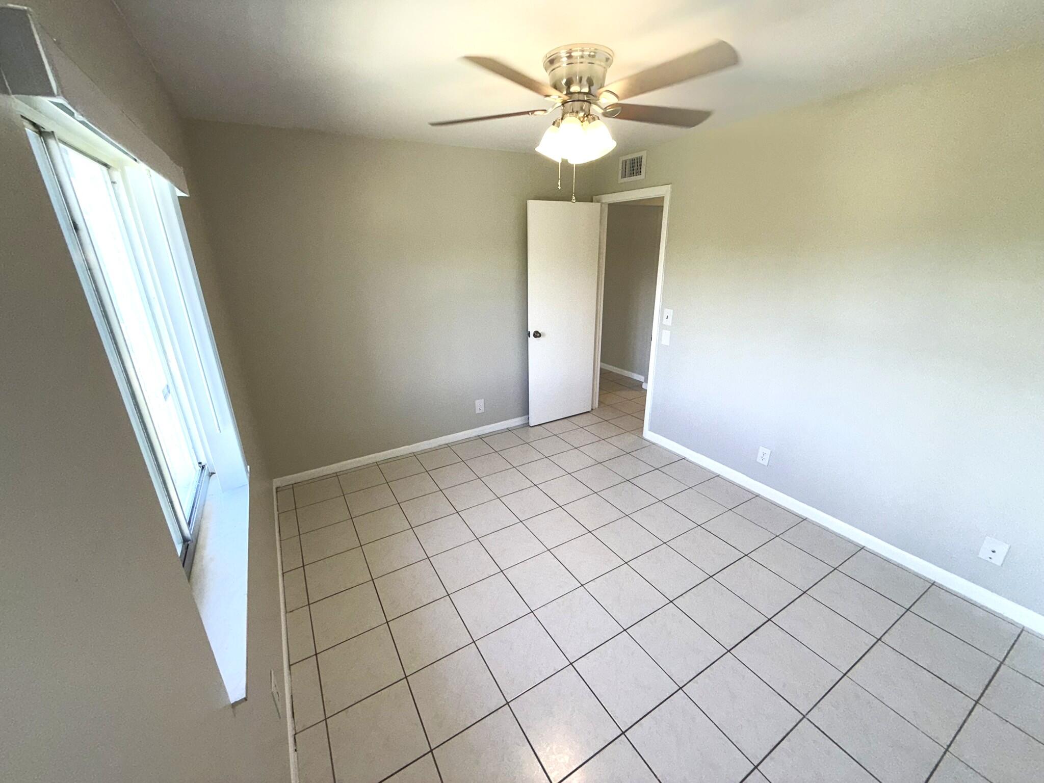 4987 Sable Pine Circle, Unit B2 West Palm Beach, FL 33417 - Photo 12 of 12 a view of an empty room and window