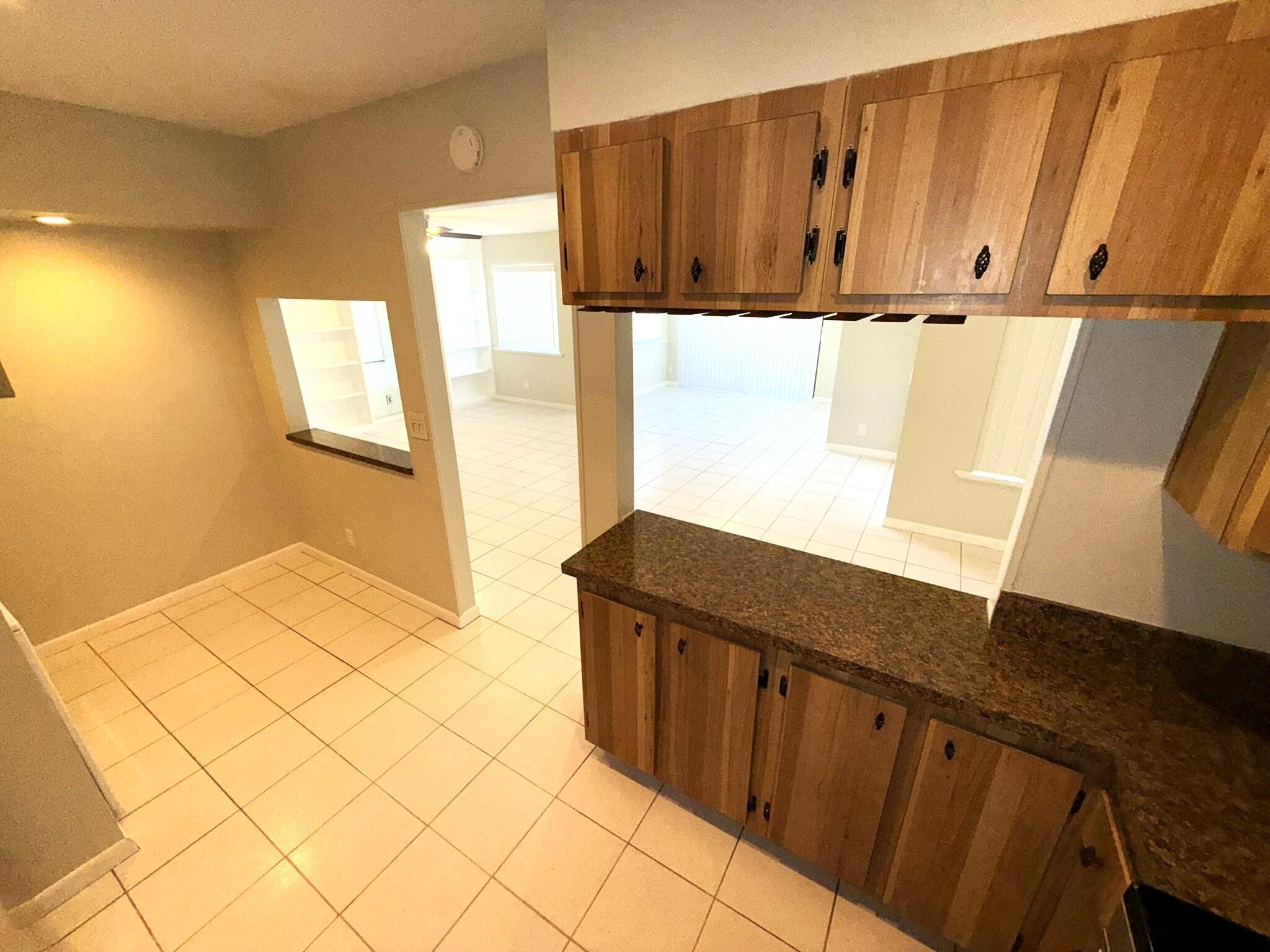 4987 Sable Pine Circle, Unit B2 West Palm Beach, FL 33417 - Photo 6 of 12 a view of a kitchen with wooden floor