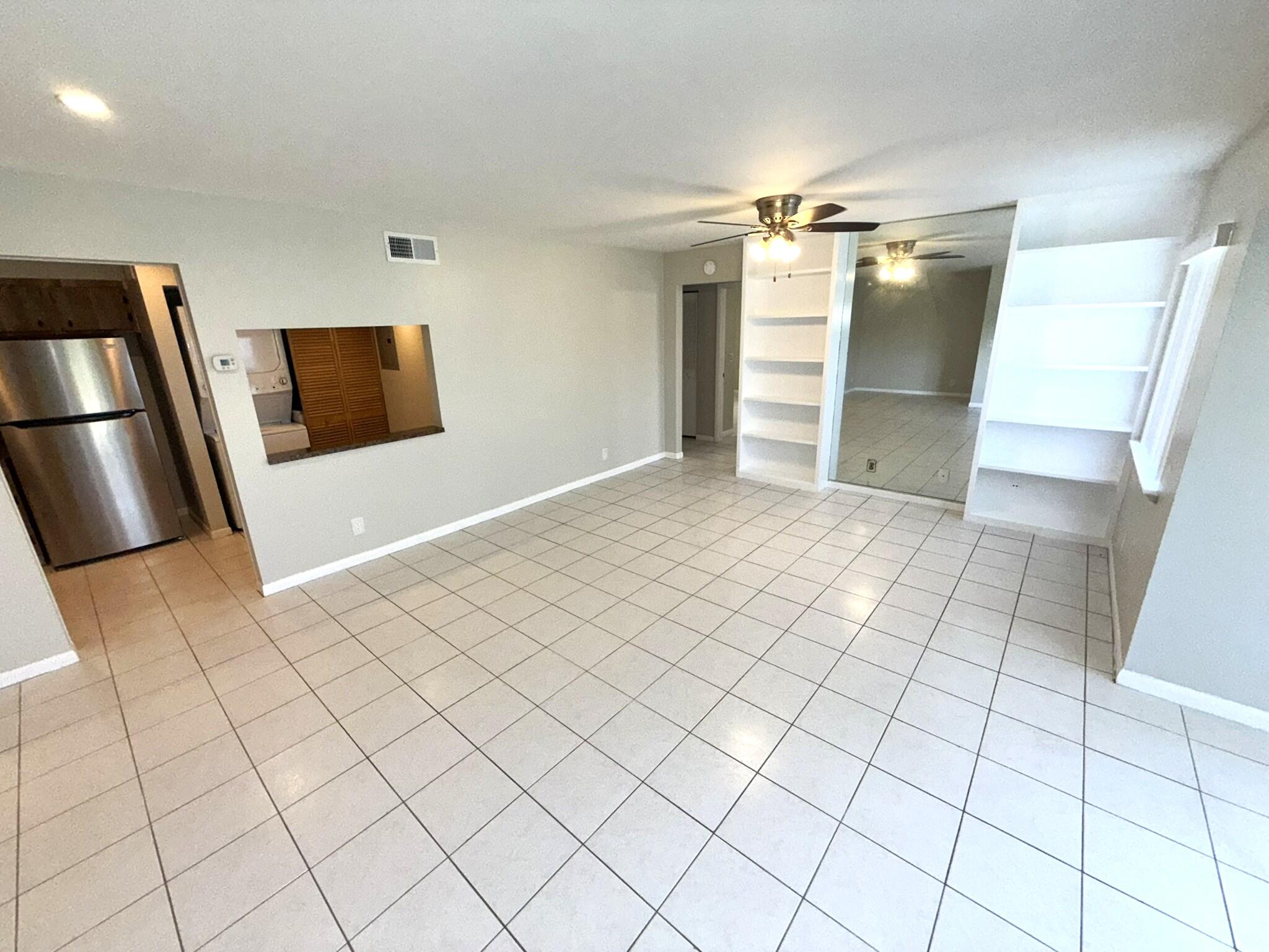 4987 Sable Pine Circle, Unit B2 West Palm Beach, FL 33417 - Photo 8 of 12 a view of a livingroom with furniture and an empty room