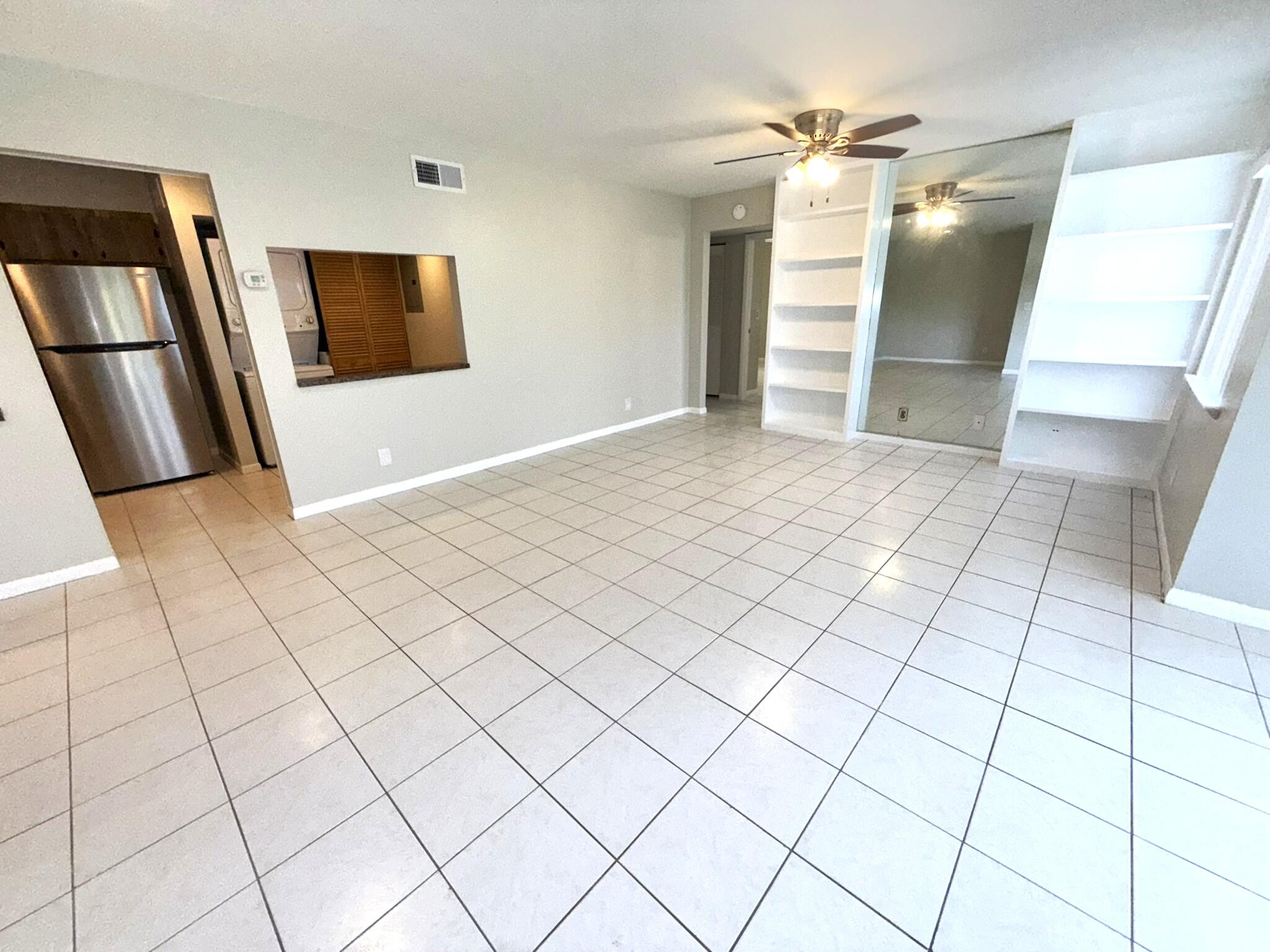 4987 Sable Pine Circle, Unit B2 West Palm Beach, FL 33417 - Photo 9 of 12 a view of a livingroom with an entryway and a ceiling fan