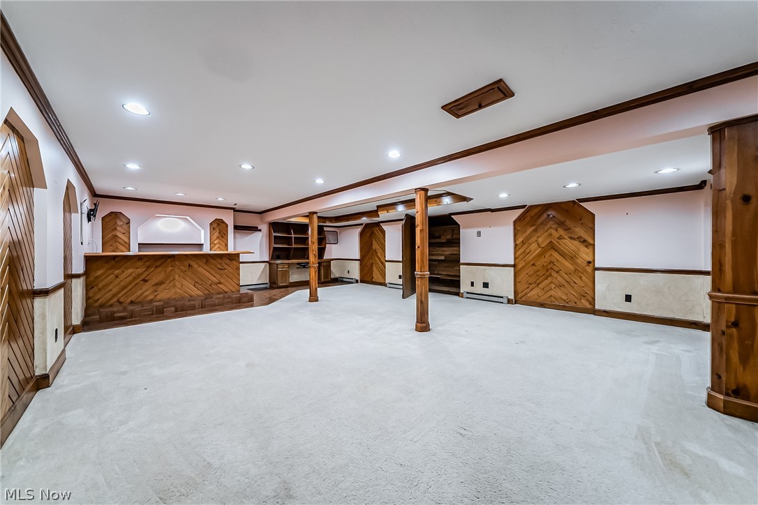 28575 Cannon Road Solon, OH 44139 - Photo 27 of 36 Basement featuring crown molding, carpet flooring, and wooden walls